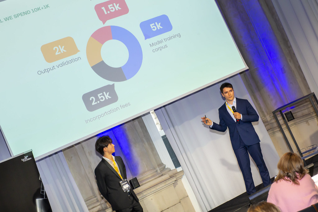 Daniele Lin on stage at TEF Ignition pitching Plynx